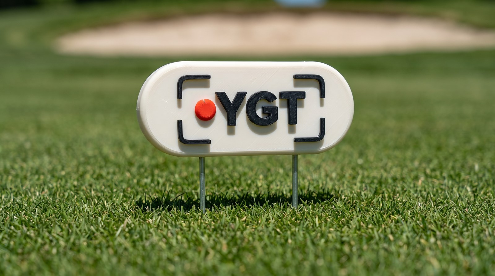 YGT Broadcast Bar — bone pill plaque with black YGT lettering and a red record dot on twin steel stakes
